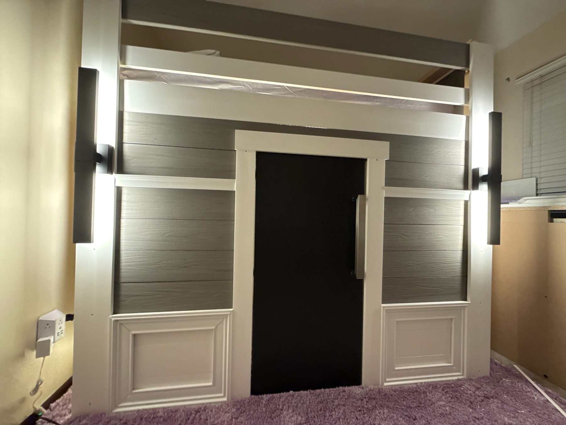 Playhouse front elevation built by Dallas Manker — gray cladding, black door