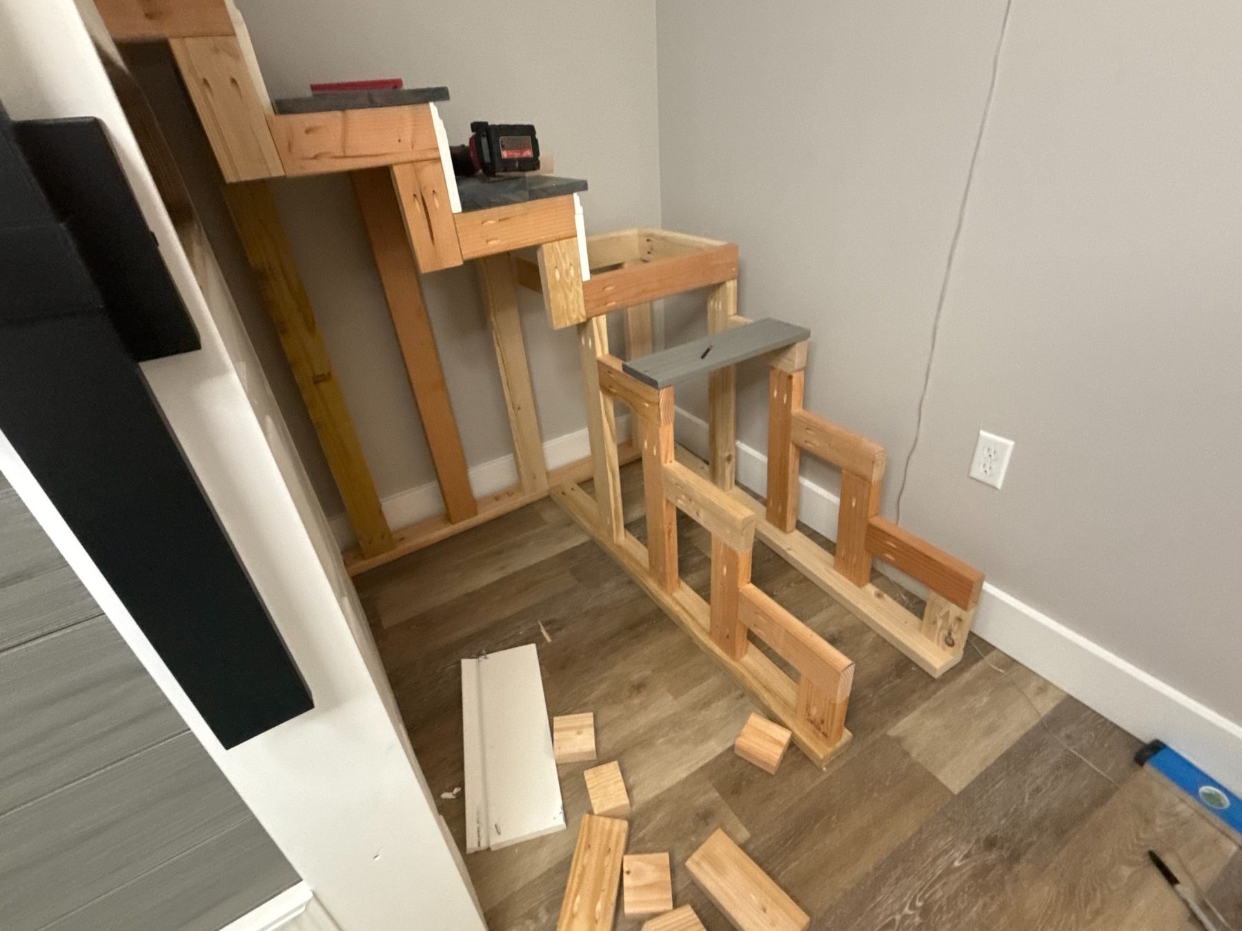 Dallas Manker framing stairs in place from bare lumber